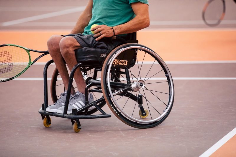 player on court playing wheelchair tennis